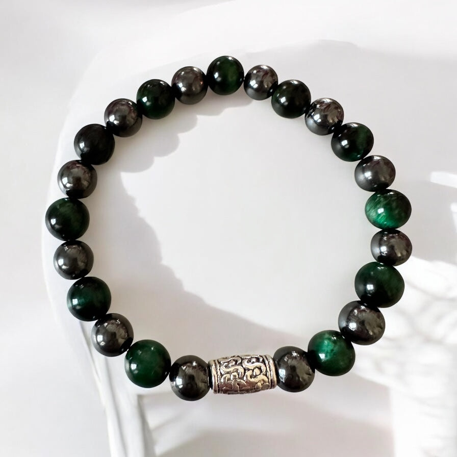 Handmade men’s bracelet with deep green tiger eye and black-silver hematite beads, accented by an engraved silver-tone barrel 