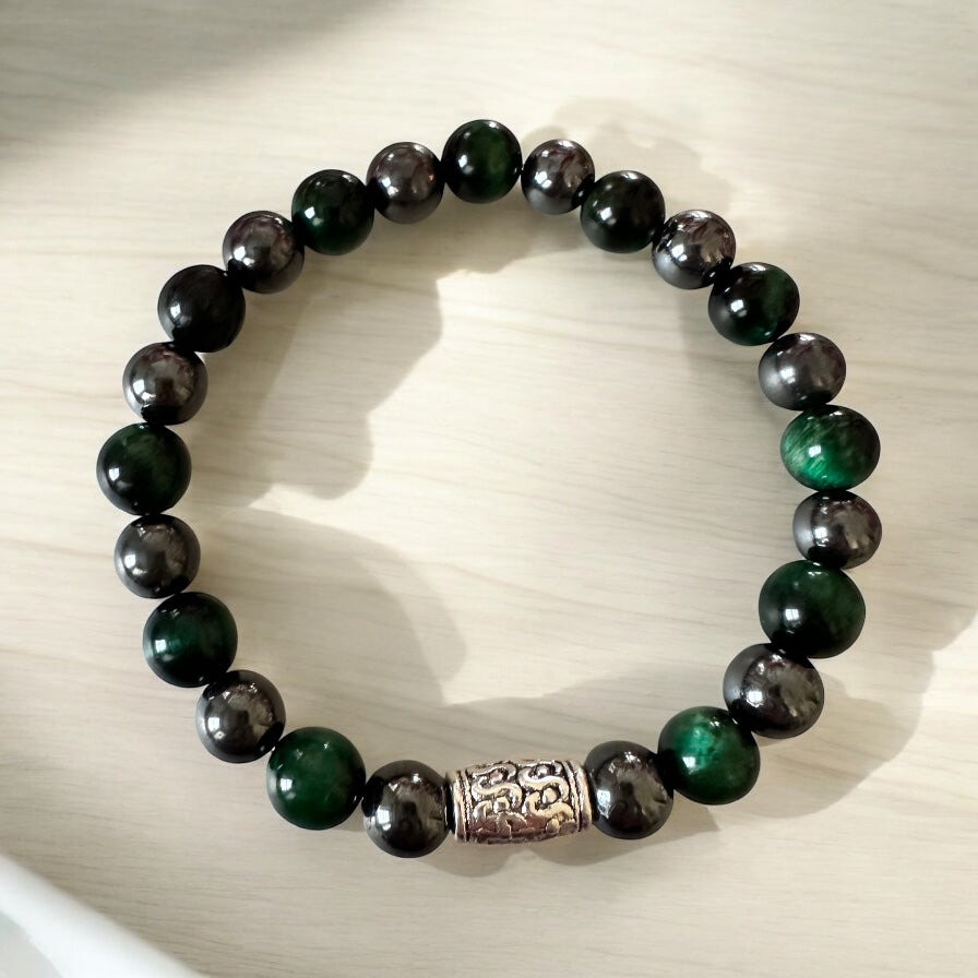 Handmade men’s bracelet with deep green tiger eye and black-silver hematite beads, accented by an engraved silver-tone barrel 