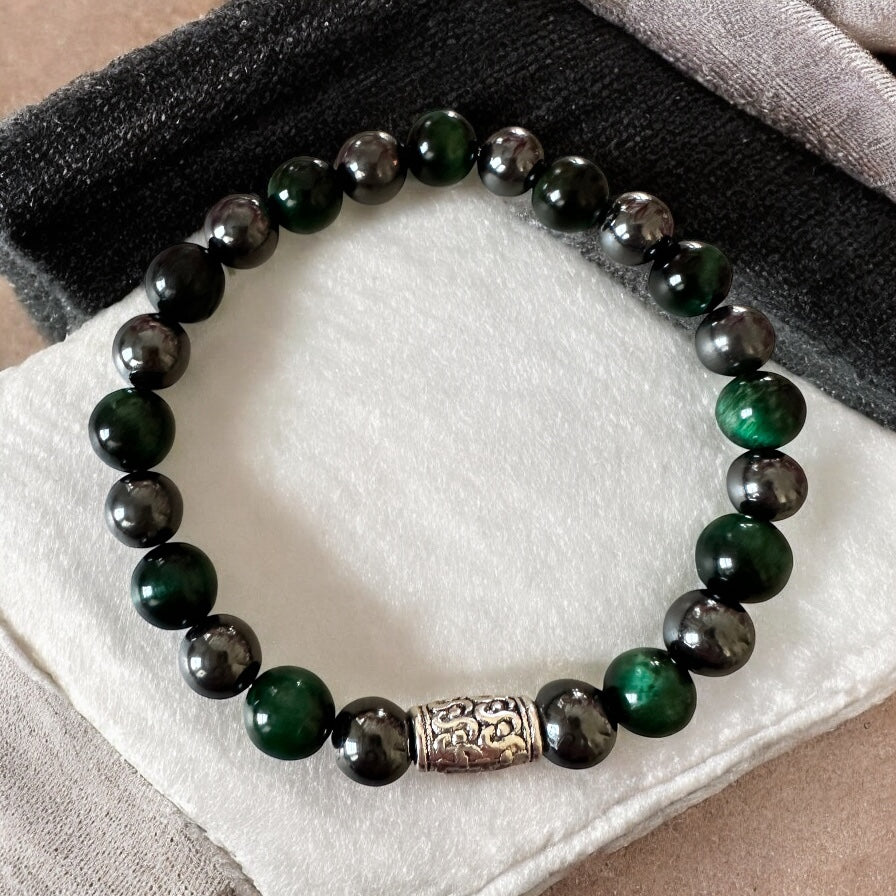 Handmade men’s bracelet with deep green tiger eye and black-silver hematite beads, accented by an engraved silver-tone barrel 