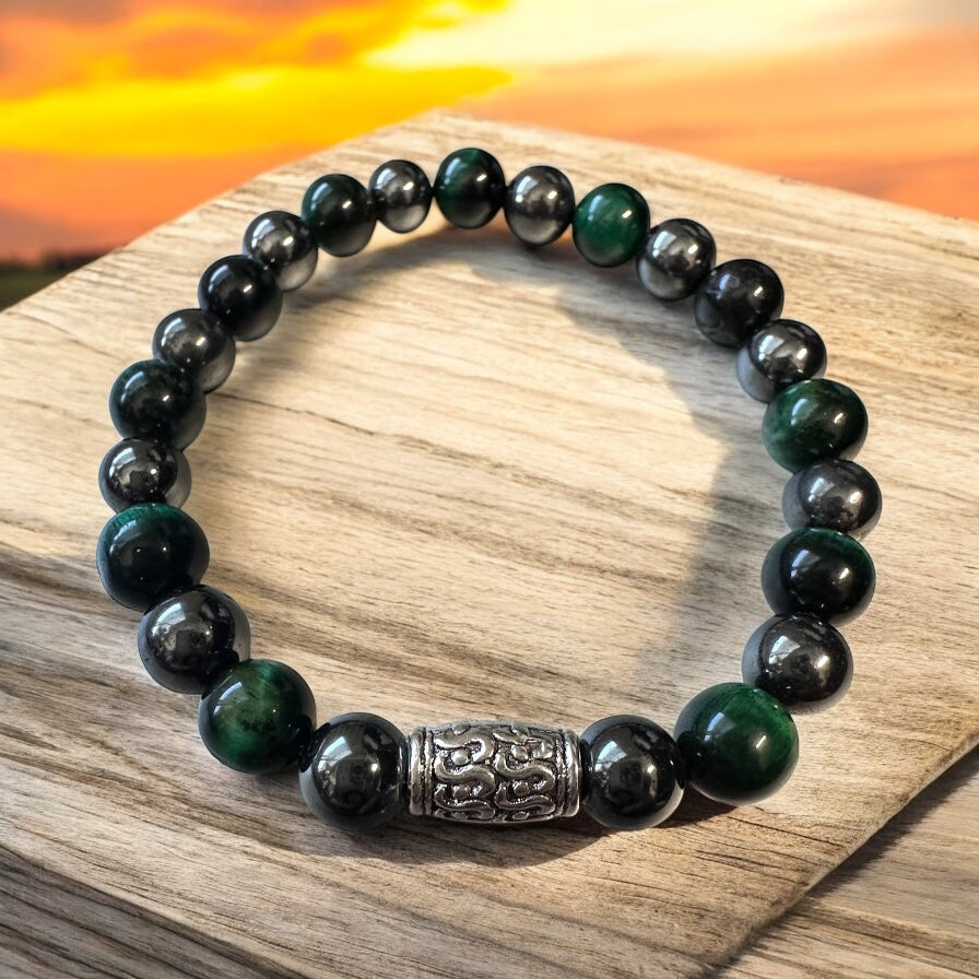 Handmade men’s bracelet with deep green tiger eye and black-silver hematite beads, accented by an engraved silver-tone barrel 