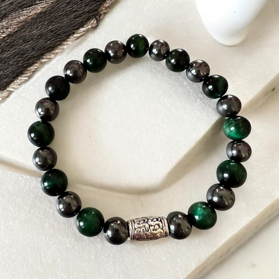 Handmade men’s bracelet with deep green tiger eye and black-silver hematite beads, accented by an engraved silver-tone barrel 