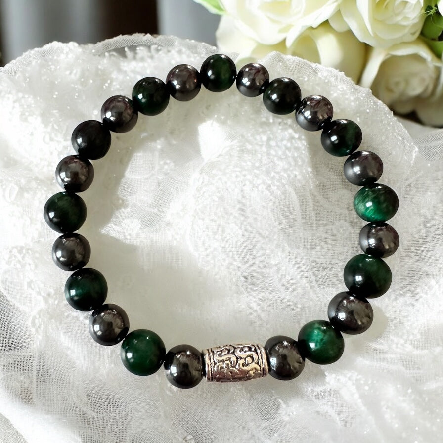 Handmade men’s bracelet with deep green tiger eye and black-silver hematite beads, accented by an engraved silver-tone barrel 