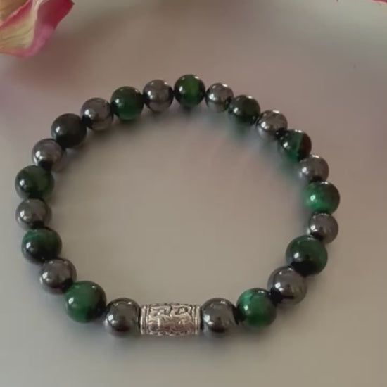 Handmade men’s bracelet with deep green tiger eye and black-silver hematite beads, accented by an engraved silver-tone barrel 